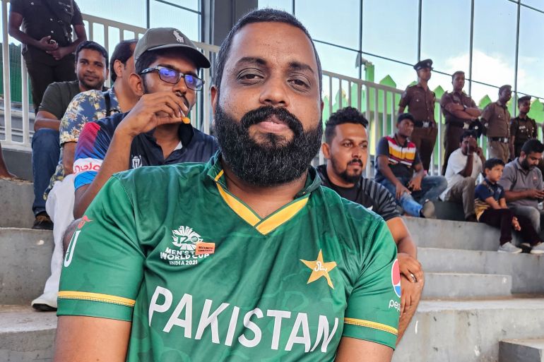 Kalana Weerasinghe wearing a green Pakistan shirt