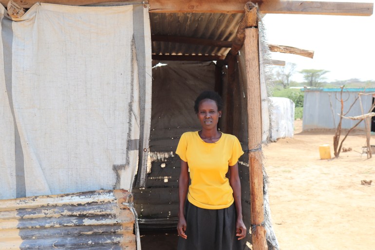 Regina Kusele, a member of the Njemps community stands outside a makeshift school structure that sits over 60 people at Kiwanja Ndege village in Marigat, Kenya's Baringo County