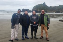 Four brothers pose for a photo on the beach in southern Chile.
