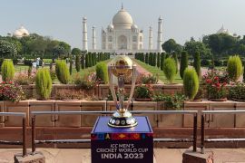 ICC world cup trophy against the backdrop of Agra. The Taj Mahal can be seen.