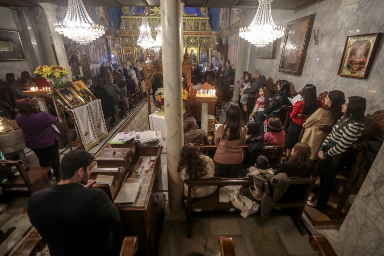 Palestinian Orthodox Christians attend the Christmas Mass at St. Porphyrius Church in Gaza City