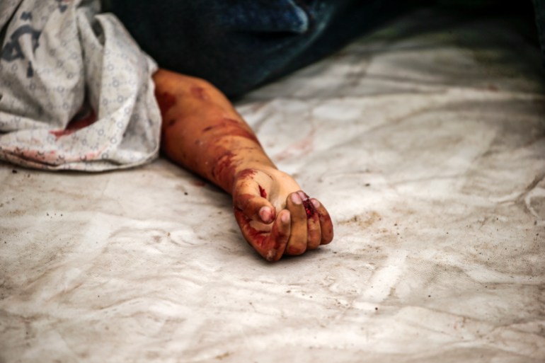 he body of a Palestinian child lies at the Al-Shifa hospital after an Israeli air strike in Gaza City, 09 October 2023.