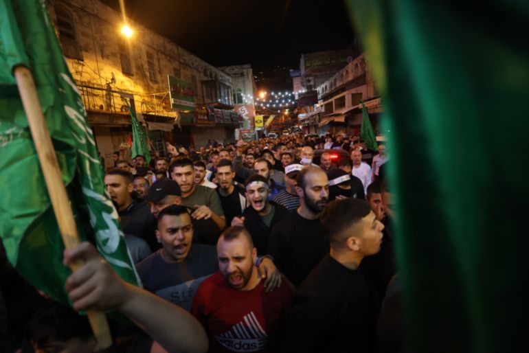 Palestinians protest against an Israeli strike on a hospital in Gaza