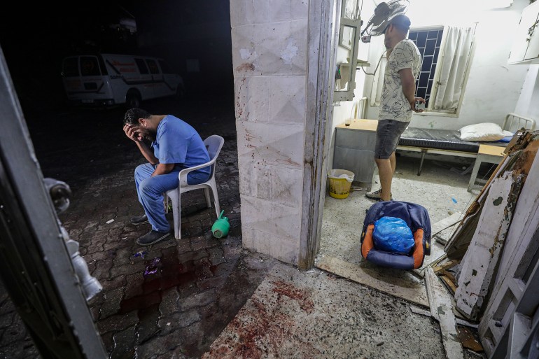 A doctor at the scene of Al Ahli hospital after an air strike