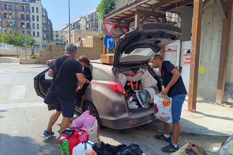 People drop off donated clothing and toys at a Tel Aviv hotel