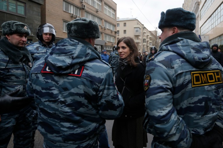 Nadezhda Tolokonnikova, a prominent member of the protest group Pussy Riot, speaks to police officers outside a courthouse in Moscow February 24, 2014. Russian police detained dozens of protesters on Monday outside a Moscow courthouse where a judge was expected to sentence eight defendants convicted of attacking police at a 2012 demonstration against President Vladimir Putin. REUTERS/Maxim Shemetov (RUSSIA - Tags: CIVIL UNREST CRIME LAW POLITICS TPX IMAGES OF THE DAY)