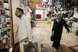 An Israeli man walks into a shop as a Palestinian woman stands behind him in Jerusalem's Old City September 10, 2015. While Israel remains predominantly Jewish, Arab numbers within the area of historic Palestine are now close to eclipsing the Jewish population, creating a dilemma for supporters of a "one-state solution" to the region's conflict. REUTERS/Ammar Awad