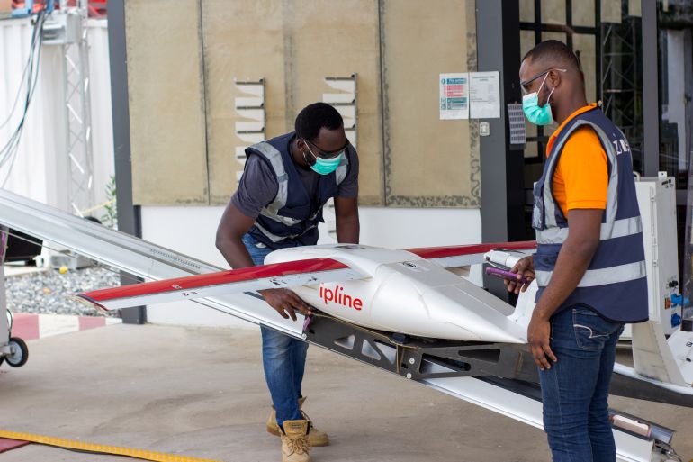 Flight operators perform pre-flight checks on a drone, amid the coronavirus disease (COVID-19) outbreak in Accra