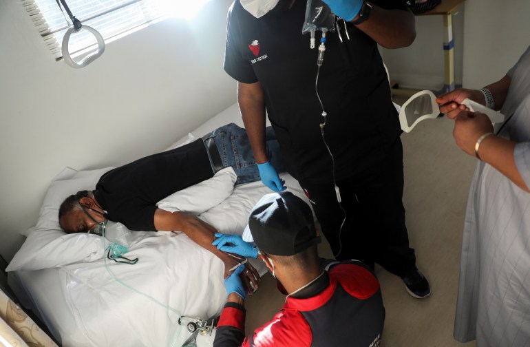 Paramedics attend to a patient during the COVID-19 outbreak in Johannesburg