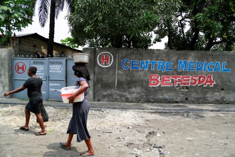 People walk outside the Bethesda Medical Center, in Ngaba a neighbourhood of Kinshasa, Democratic Republic of Congo