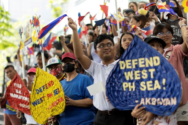 Protesters in the Philippines marking the 7th anniversary of the international court ruling against China's nine-dash line. They are carrying placards.