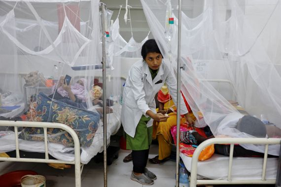 A nurse provides treatment to a dengue-infected patient at the Shaheed Suhrawardy Medical College and Hospital in Dhaka, Bangladesh.