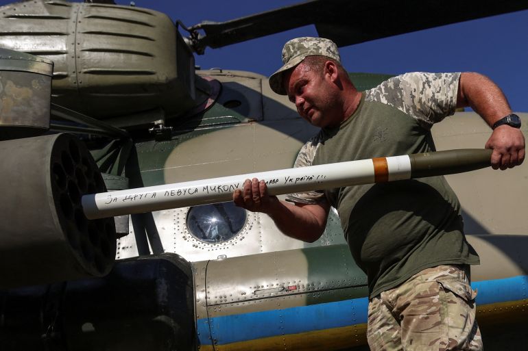 A Ukrainian soldier loading a missile into a helicopter in eastern Ukraine