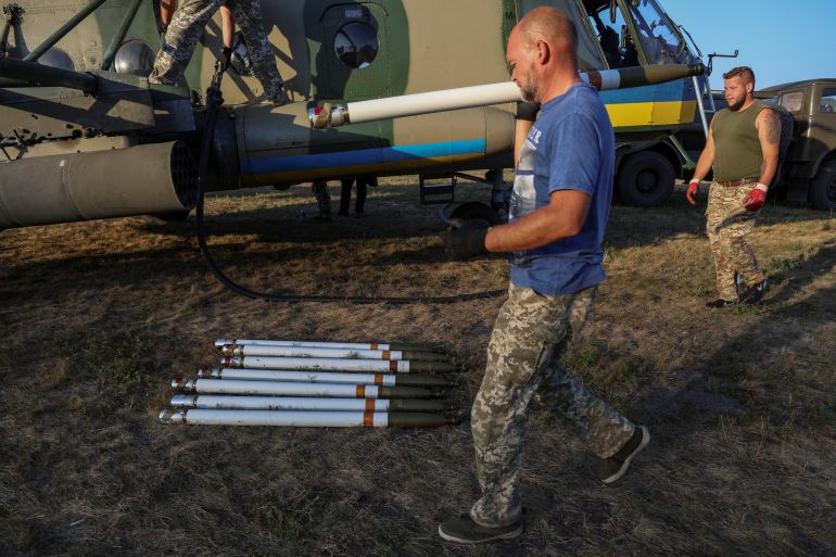 A Ukrainian serviceman carries an unguided missile for a launcher of a military Mi-8 helicopter, amid Russia's attack on Ukraine, in an undisclosed location in Eastern Ukraine, September 29, 2023. REUTERS/Oleksandr Ratushniak