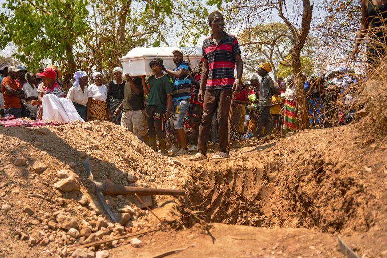 People prepare to bury one of multiple artisanal miners killed when a disused mining shaft collapsed near Chegutu, Zimbabwe