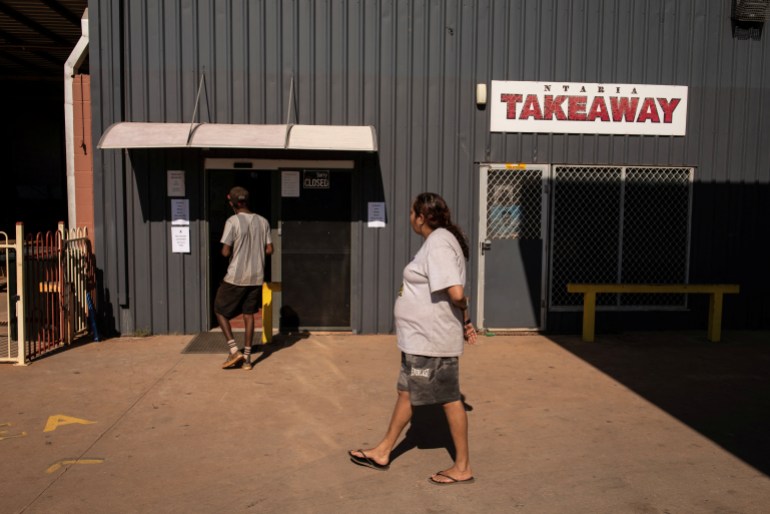 Aboriginal people outside a takeaway shop