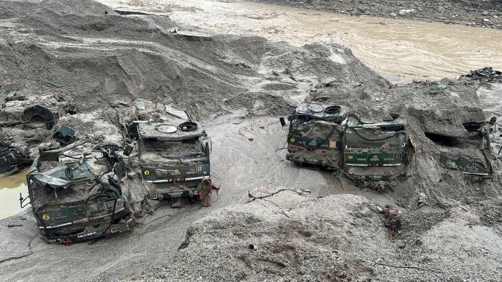 Trucks buried in mud are seen in an area affected by flood in Sikkim in this undated handout image released by the Indian Army on October 5, 2023.