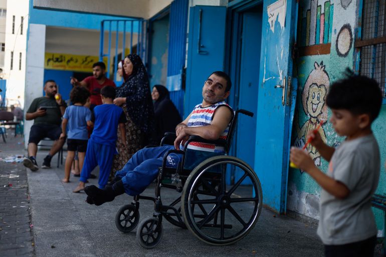 Palestinians fleeing Israeli air strikes take refuge in a school run by the United Nations in Gaza City