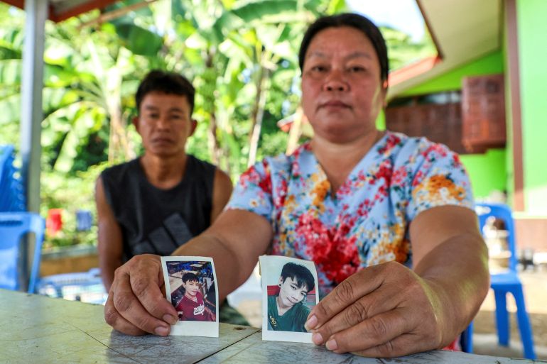 Thawatchai and Thongkoon On-kaew, parents of Natthaporn, who was working in Israel and has been abducted in the ongoing conflict between Israel and the Palestinian Islamist group Hamas, hold up his pictures during an interview with Reuters at their house in Nakhon Phanom, Thailand,