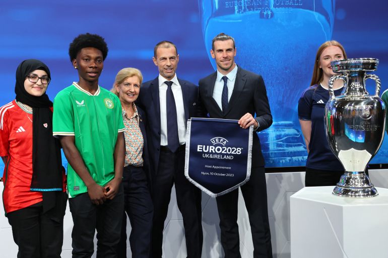 UEFA president Aleksander Ceferin and UK-Ireland ambassadors including Gareth Bale pose with the trophy after UK and Ireland are announced as the hosts for Euro 2028