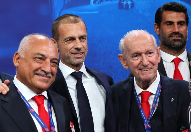 UEFA president Aleksander Ceferin, Turkey football federation president Mehmet Buyukeksi and delegation staff pose with the trophy 