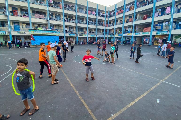 Palestinian children, who fled their houses due to Israeli strikes, play as they shelter in a United Nations-run school, in Gaza City
