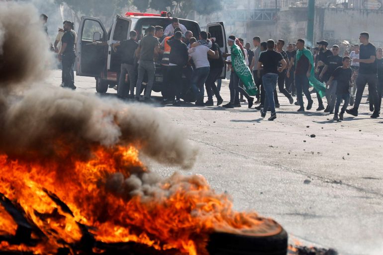 Palestinians take part in a protest following Israeli strikes on Gaza, in Nablus,