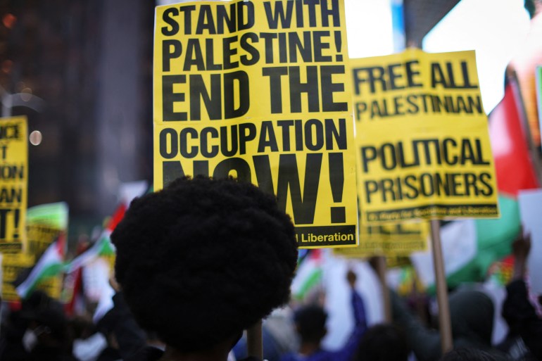 People attend a demonstration in Times Square to express solidarity with Palestinians in Gaza