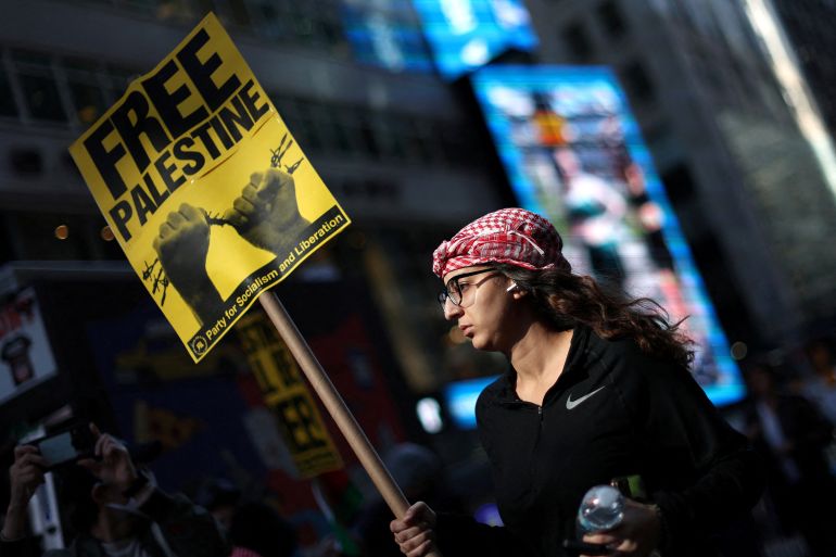 People attend a demonstration in Times Square to express solidarity with Palestinians in Gaza