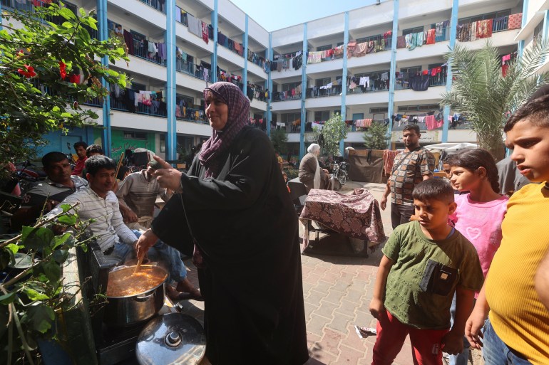 Palestinians, who fled their houses amid Israeli strikes, shelter at a United Nations-run school