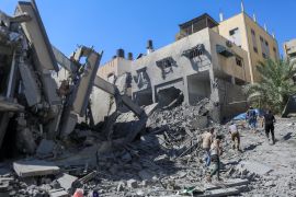 Palestinians run past the rubble following Israeli strikes in Gaza City