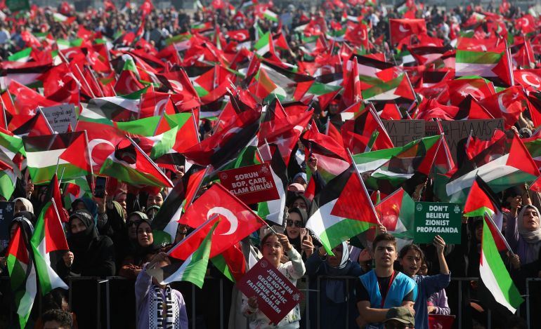 Demonstrators wave Turkish and Palestinian flags during a rally in solidarity with Palestinians