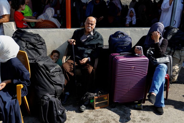 Palestinians with dual citizenship gather outside Rafah border crossing with Egypt in the hope of getting permission to leave Gaza