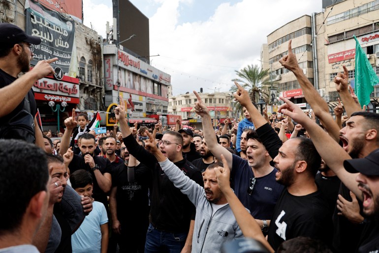 Palestinians take part in a protest in support of the people in Gaza, after hundreds of Palestinians were killed in a blast at Al-Ahli hospital in Gaza that Israeli and Palestinian officials blamed on each other, in Nablus in the Israeli-occupied West Bank 