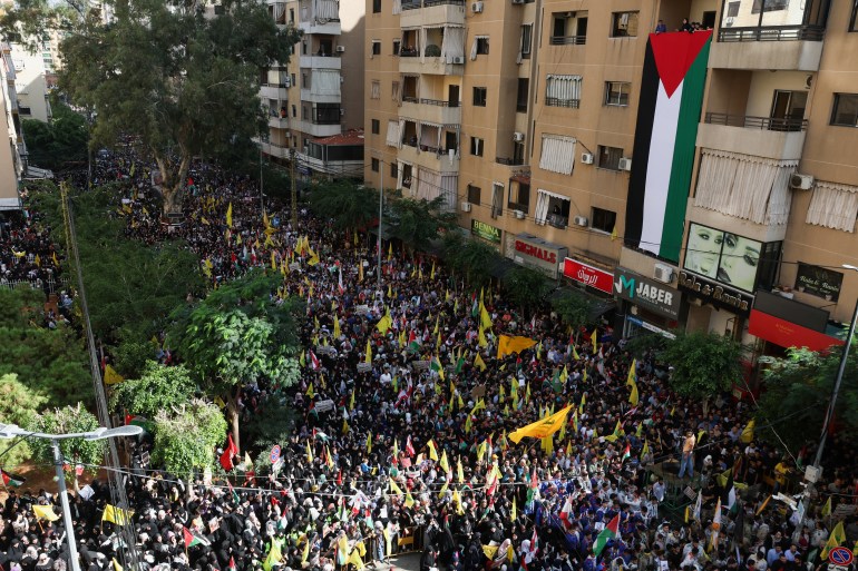 Hezbollah supporters take part in a protest, after hundreds of Palestinians were killed