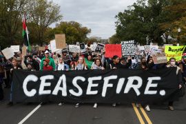 Protesters march past the U.S. Capitol building as they take part in a protest calling for a ceasefire in Gaza, in Washington