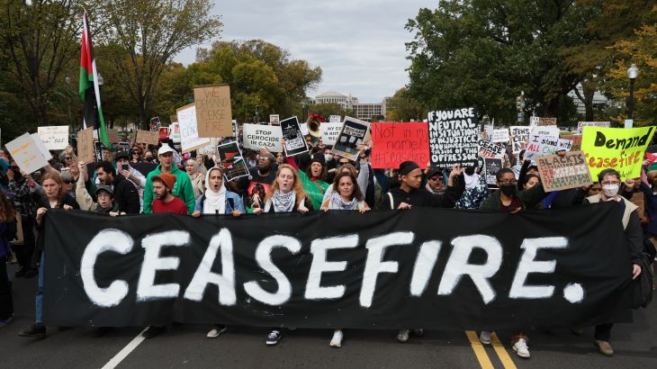Protesters march past the U.S. Capitol building as they take part in a protest calling for a ceasefire in Gaza, in Washington
