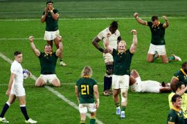 South Africa's Vincent Koch, Deon Fourie and teammates celebrate after the match as South Africa reach the final while England's Maro Itoje and George Ford look dejected