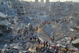 Palestinians search for casualties at the site of Israeli strikes on houses in Jabalia refugee camp in the northern Gaza Strip