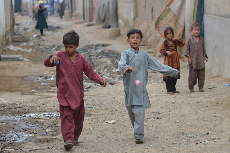 Afghan children play at an Afghan refugee camp in Karachi.
