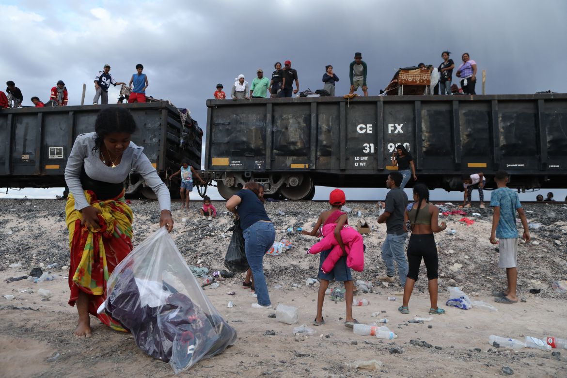 Migrant people, mostly from Venezuela, remain stranded after the goods train they were travelling on to Ciudad Juarez stopped in the desert