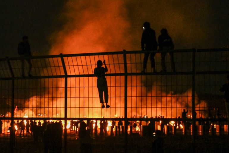 Flames rise from the Kanjuruhan stadium after some of those attending the vigil set it alight