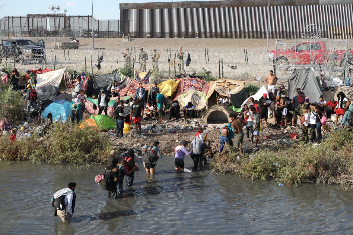 Migrant people cross the Rio Grande to seek asylum in the US,