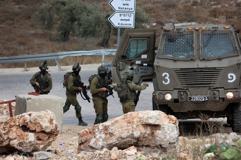 Israeli soldiers patrol near the West Bank city of Tulkarm where two Palestinians were reportedly killed during clashes with Israeli forces on October 5, 2023. (Photo by Zain JAAFAR / AFP)