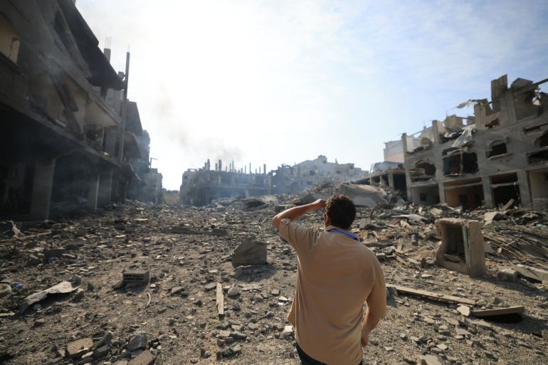 A man looks at the destruction in a ravaged neighbourhood in Gaza City early on October 11, 2023, following overnight Israeli airstrikes amid continuing battles between Israel and the Hamas movement. - The death toll from five days of ferocious fighting between Hamas and Israel rose sharply overnight as Israel kept up its bombardment of Gaza after recovering the dead from the last communities near the border where Palestinian militants had been holed up.