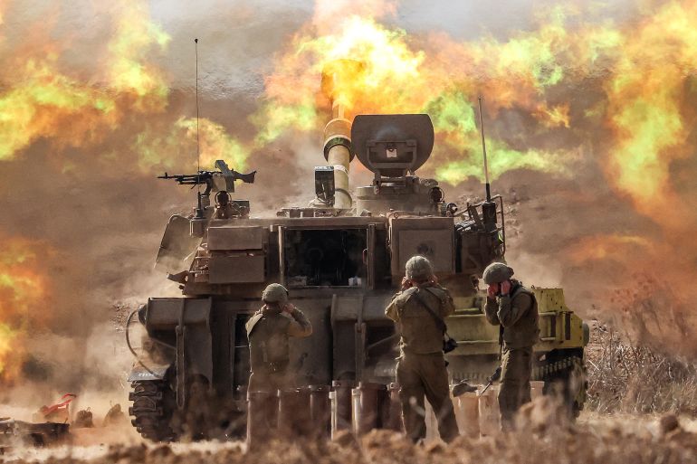 An Israeli army self-propelled howitzer fires rounds near the border with Gaza in southern Israel on October 11, 2023. Israel declared war on Hamas on October 8 following a shock land, air, and sea assault by the Gaza-based militant group. The death toll in Israel has surged above 1,200 following the worst attack in the country's 75-year history, while Gaza officials have reported 1000 people killed so far. (Photo by JACK GUEZ / AFP)