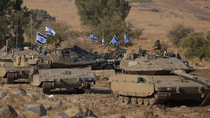 Israeli Merkava tanks are positioned in the upper Galilee in northern Israel near the border with Lebanon