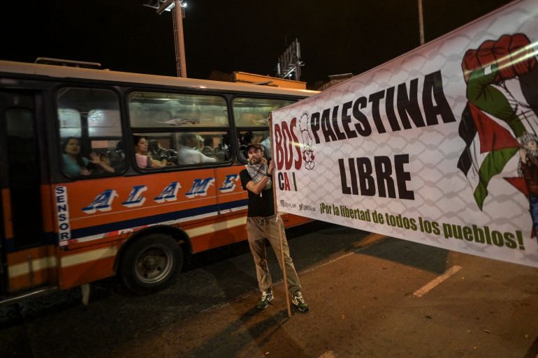 A man holds a sign reading "Free Palestine" during a demonstration in support of Palestinians in Cali, Colombia