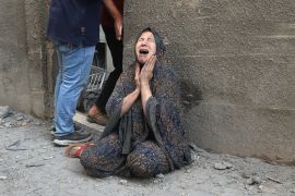A Palestinian woman reacts after an Israeli air raid on the Rafah refugee camp [Said Khatib/AFP]