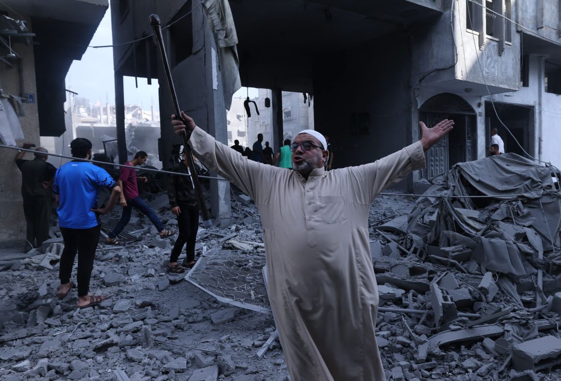 A Palestinian reacts amidst the rubble of a building after an Israeli airstrike on the Rafah
